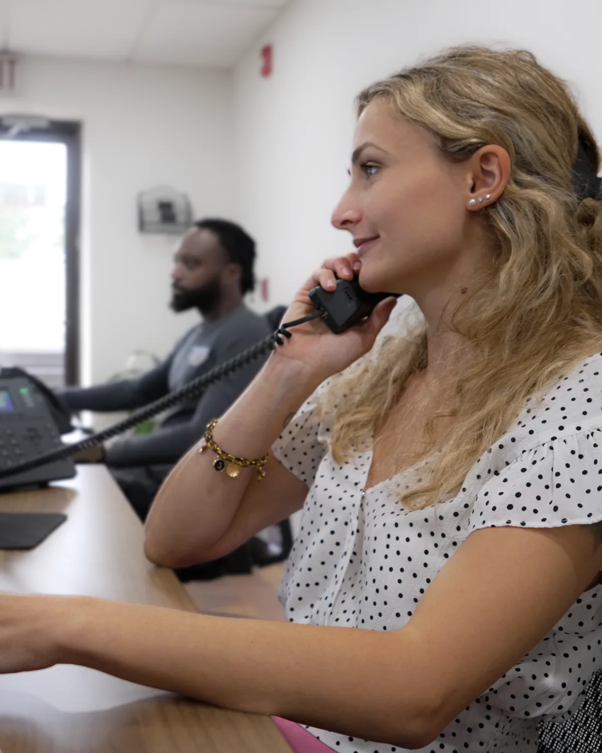 A Kintech office team member on the phone with a customer